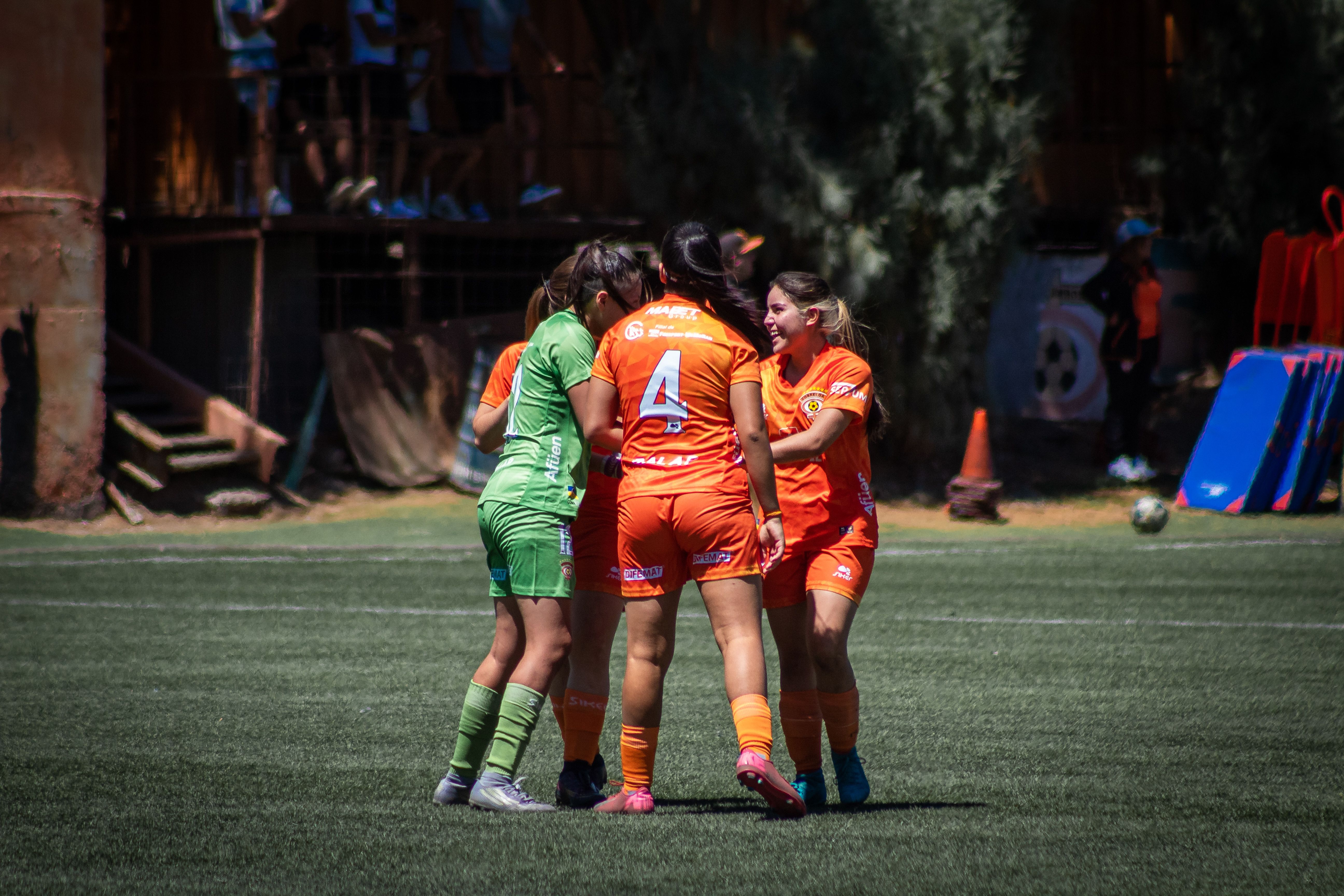 Soccer players supporting each other after a moment in the game