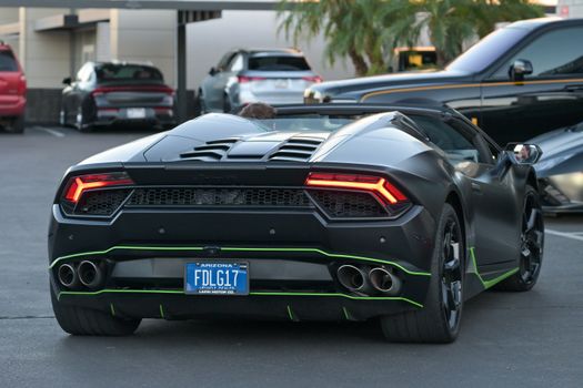 High-end sports car with sleek design captured in Arizona parking area, showcasing automotive elegance.