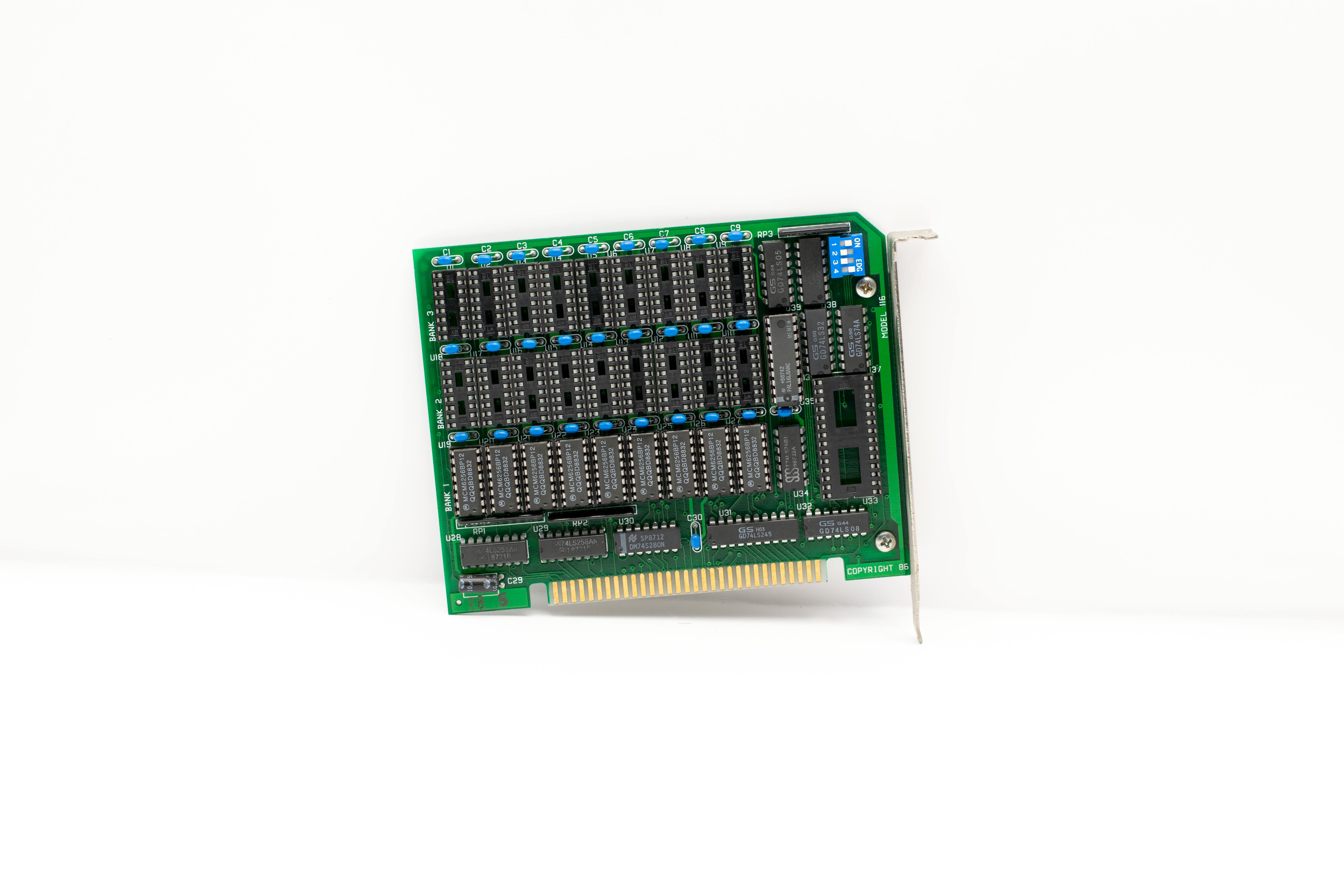 A vintage circuit board with protruding components and connectors on a white background.