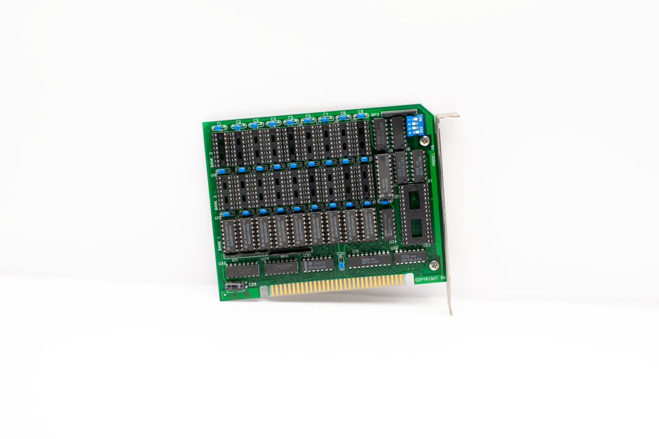 A vintage circuit board with protruding components and connectors on a white background.