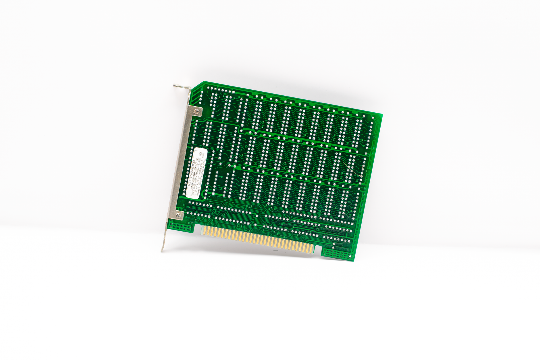 Retro green circuit board with connectors, representing early computer technology.
