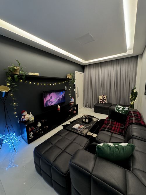 Free Contemporary living room featuring holiday decor, stylish black leather furniture, and ambient lighting. Stock Photo