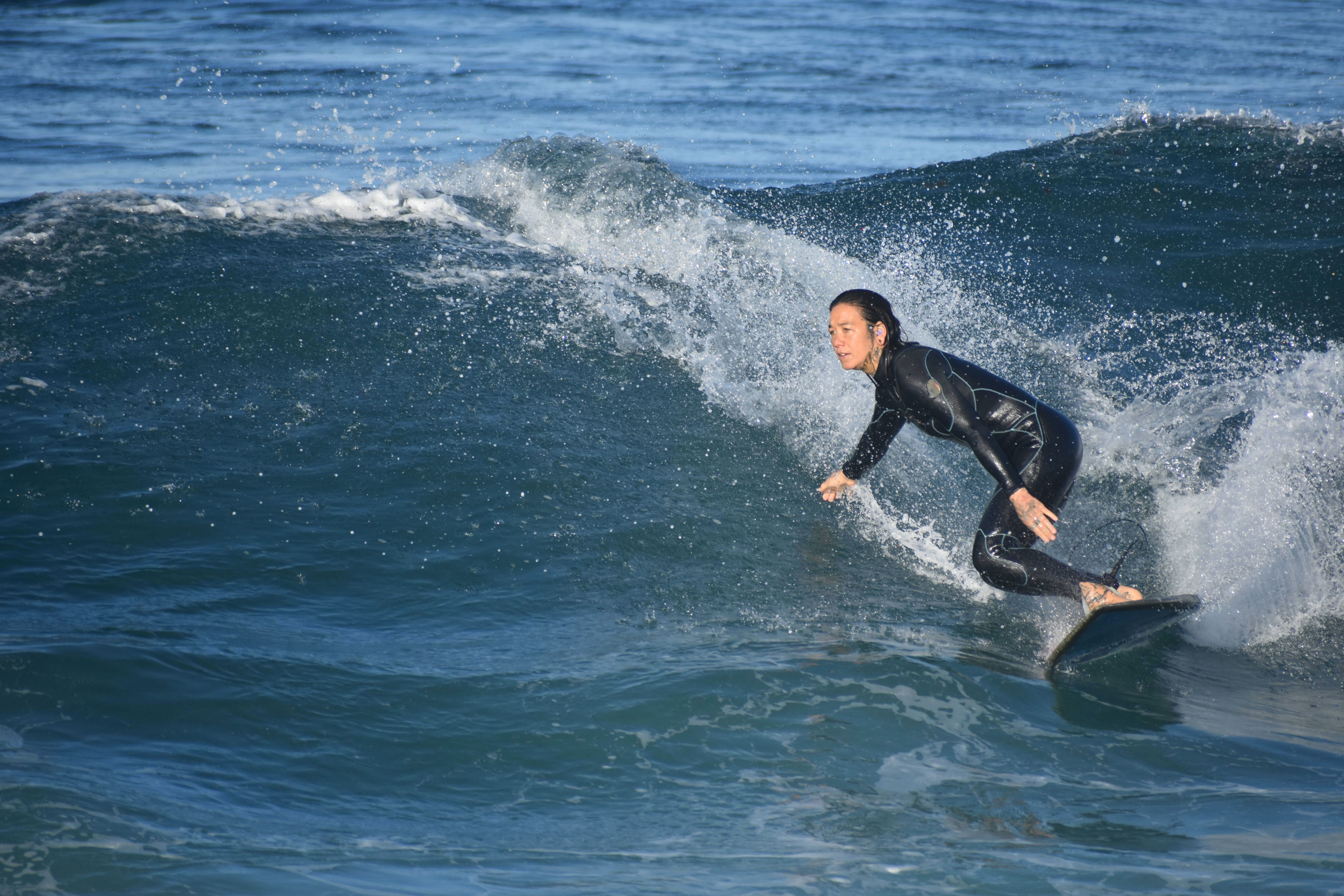 Surfer paddling out to catch a wave with perfect timing and positioning