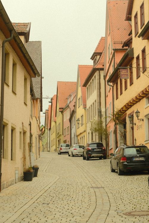 Free Picturesque cobblestone street in Rothenburg ob der Tauber, Germany, showcasing colorful historic buildings. Stock Photo