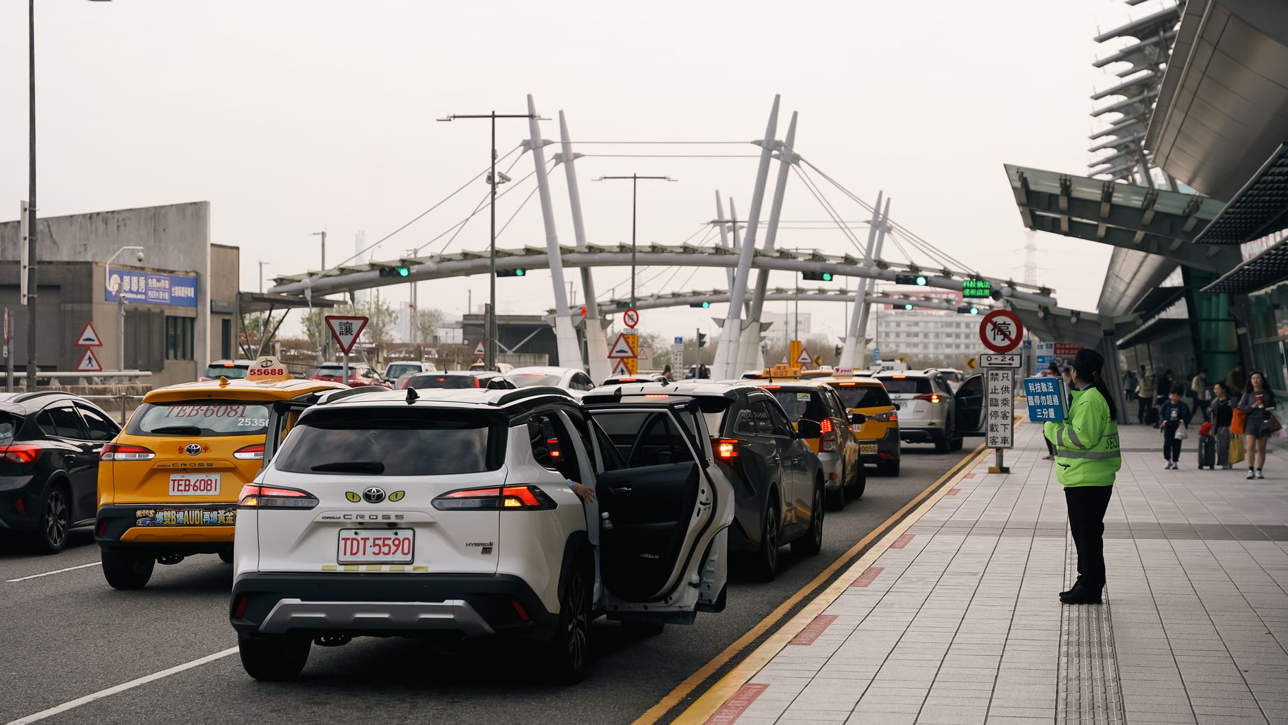 Street view of traffic with taxis and pedestrians in Taichung City, Taiwan.