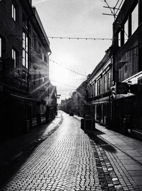 Free Atmospheric black and white photo of a cobblestone street in Jönköping, Sweden during daytime. Stock Photo