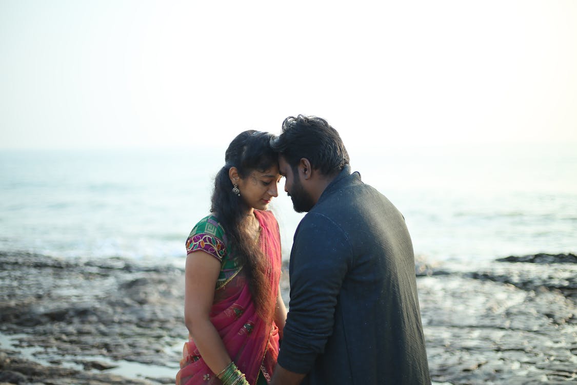 Man and Woman Standing on Beach