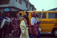 Vibrant cultural festival procession in Lagos, Nigeria, featuring traditional attire and drumming.