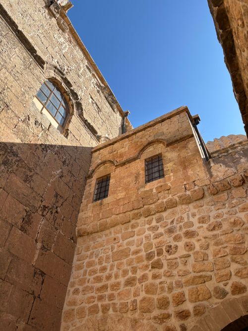 Free Upward view of historic stone architecture with clear blue sky, depicting ancient construction style. Stock Photo