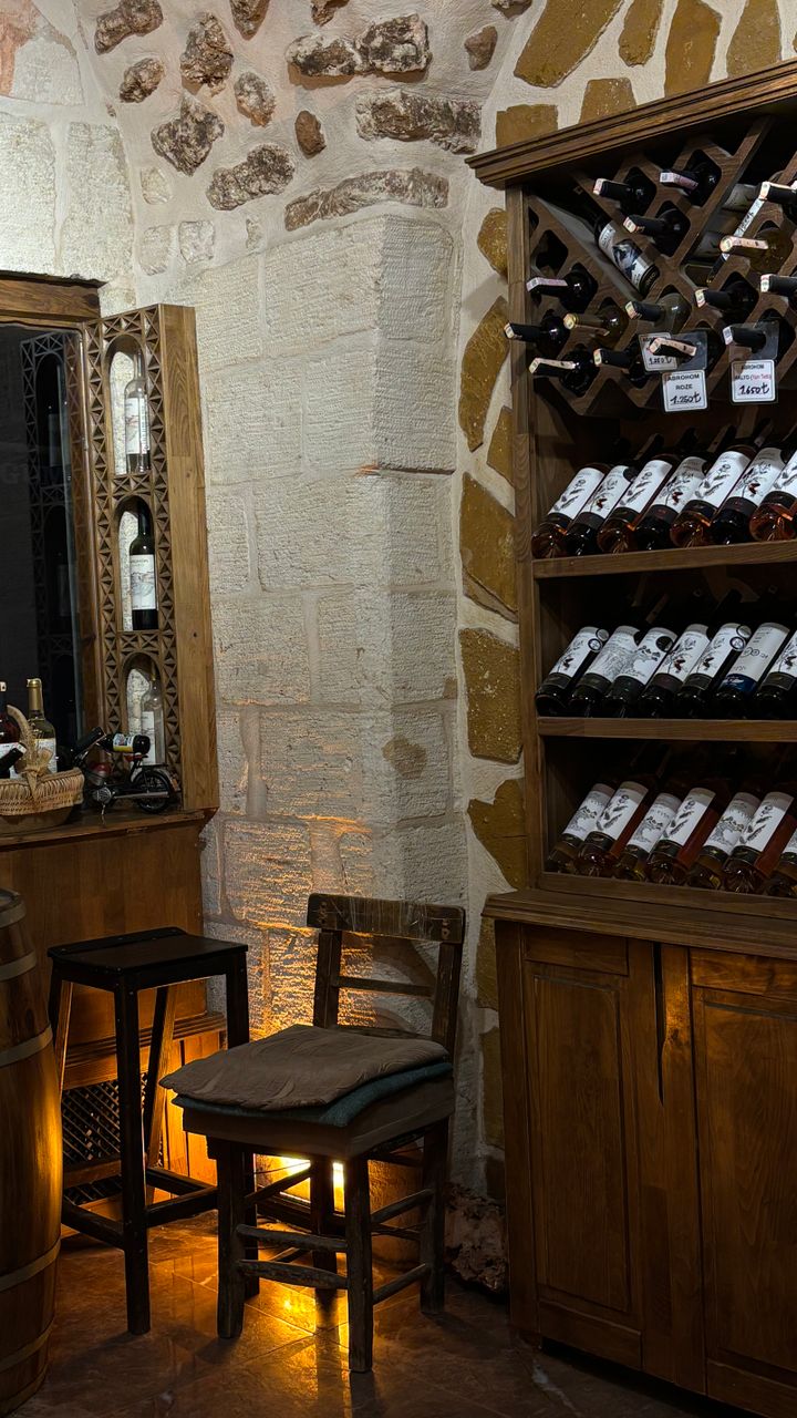 corner wine rack converted to a small coffee bar with mugs and coffee supplies