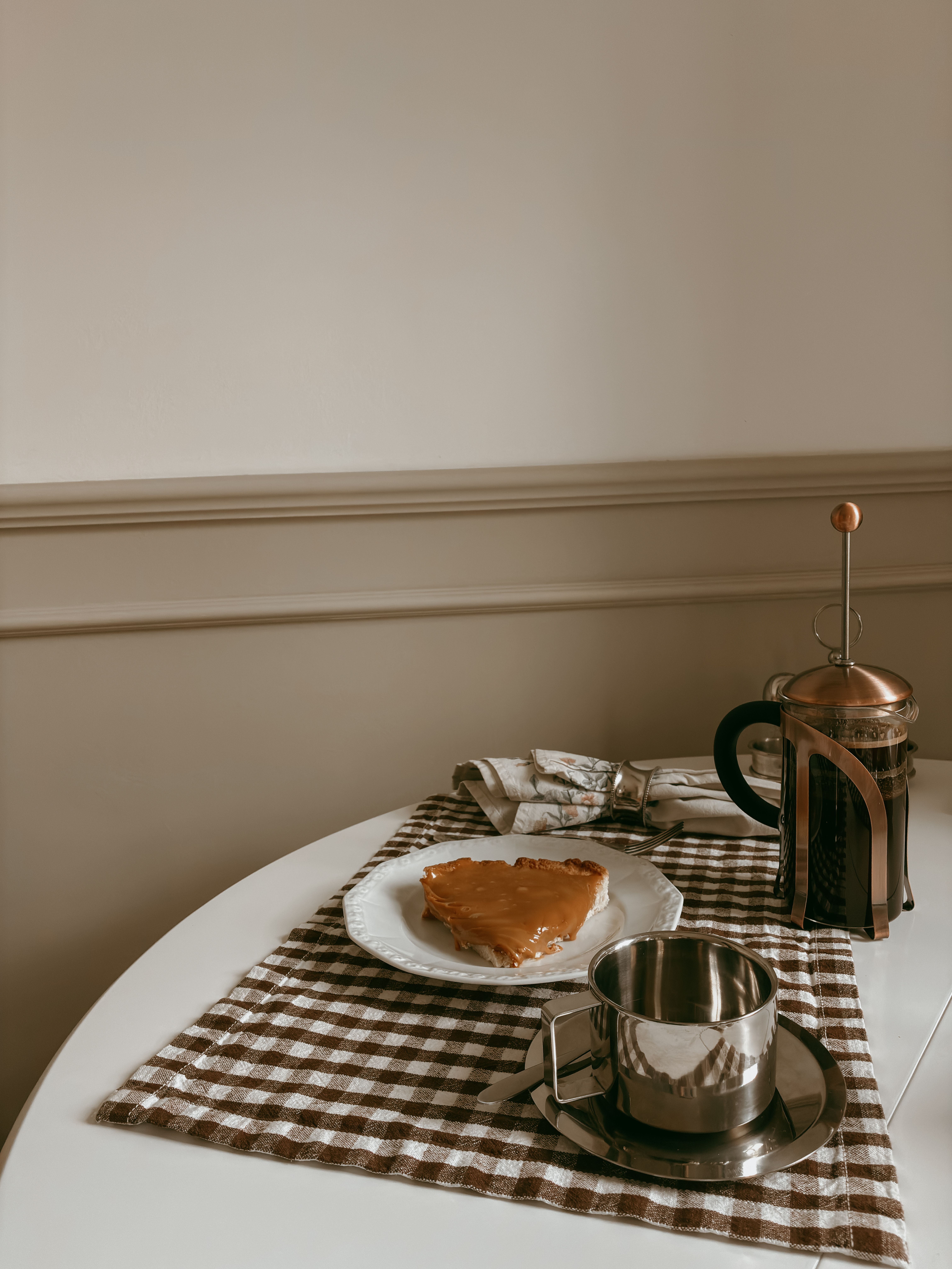 Warm, inviting breakfast table with pie, coffee, and French press.
