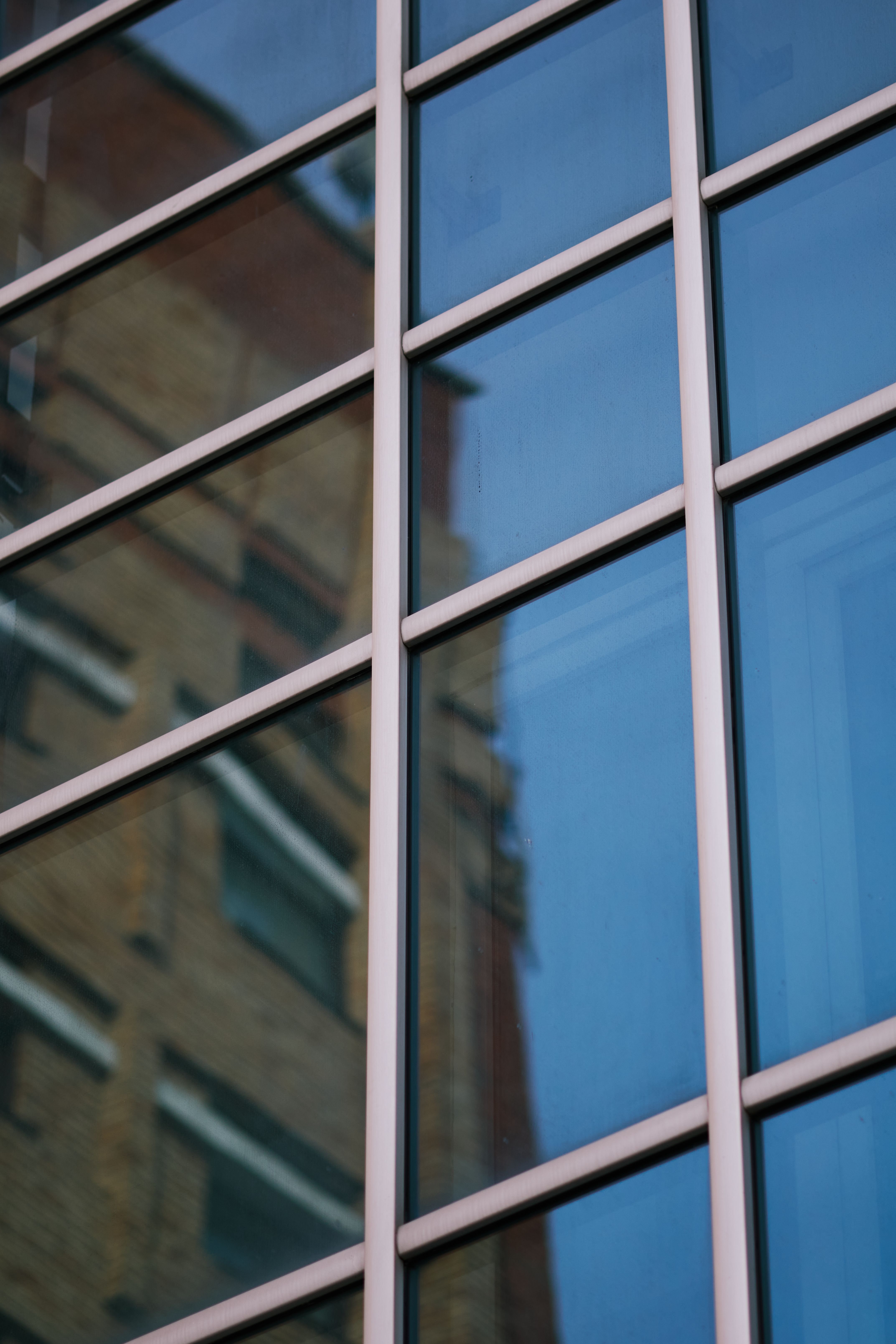 Modern Architectural Reflection in Glass Windows · Free Stock Photo