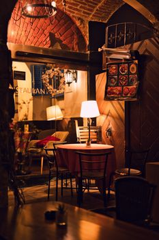 Warm and inviting restaurant ambiance with rustic brick arches and cozy lighting.