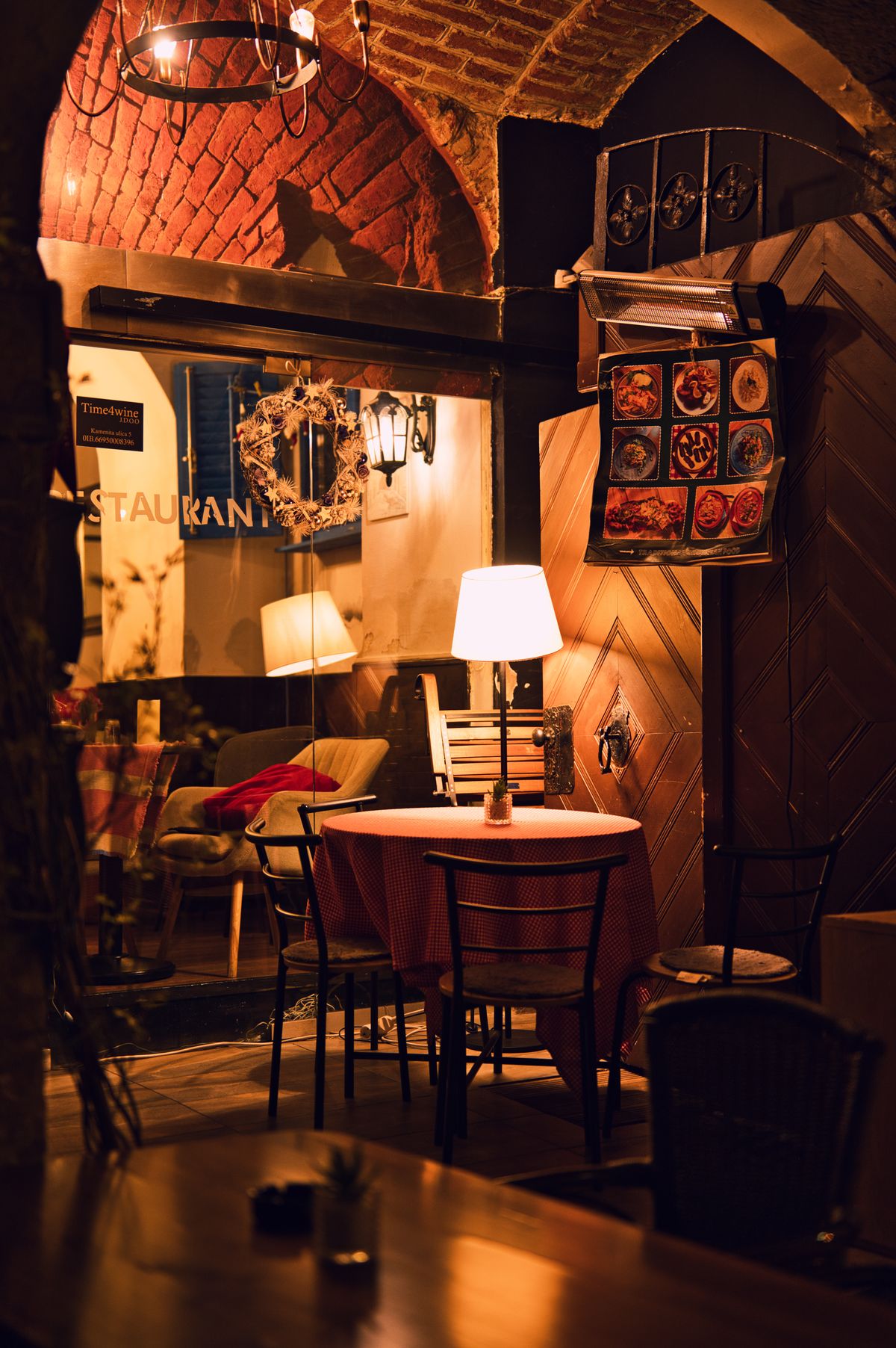Dimly lit restaurant dining room with warmly lit tables