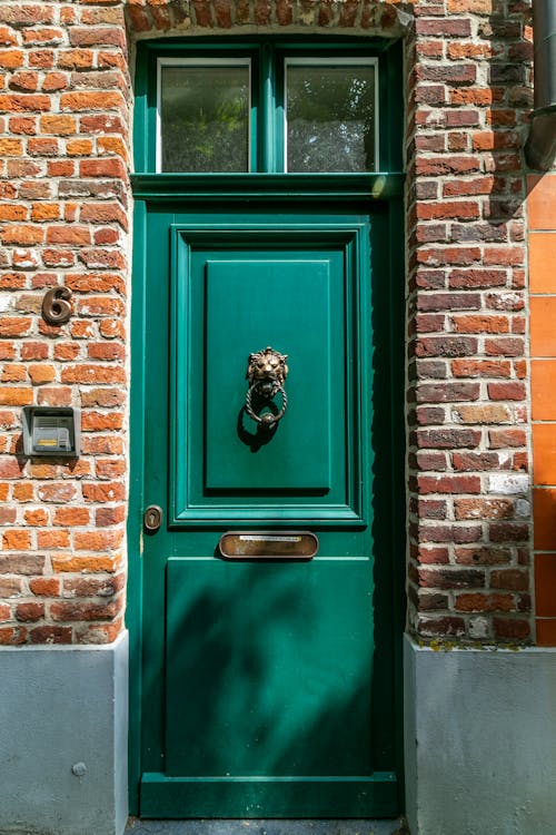 Free Green Wooden Door With Brown Brick Wall Stock Photo