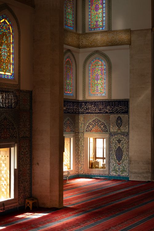Free A stunning view of a mosque interior with vibrant stained glass and intricate tile work, showcasing Islamic architecture. Stock Photo