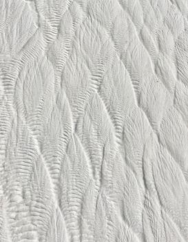 Intricate travertine patterns at Pamukkale, showcasing nature's artistry in this thermal spring formation.