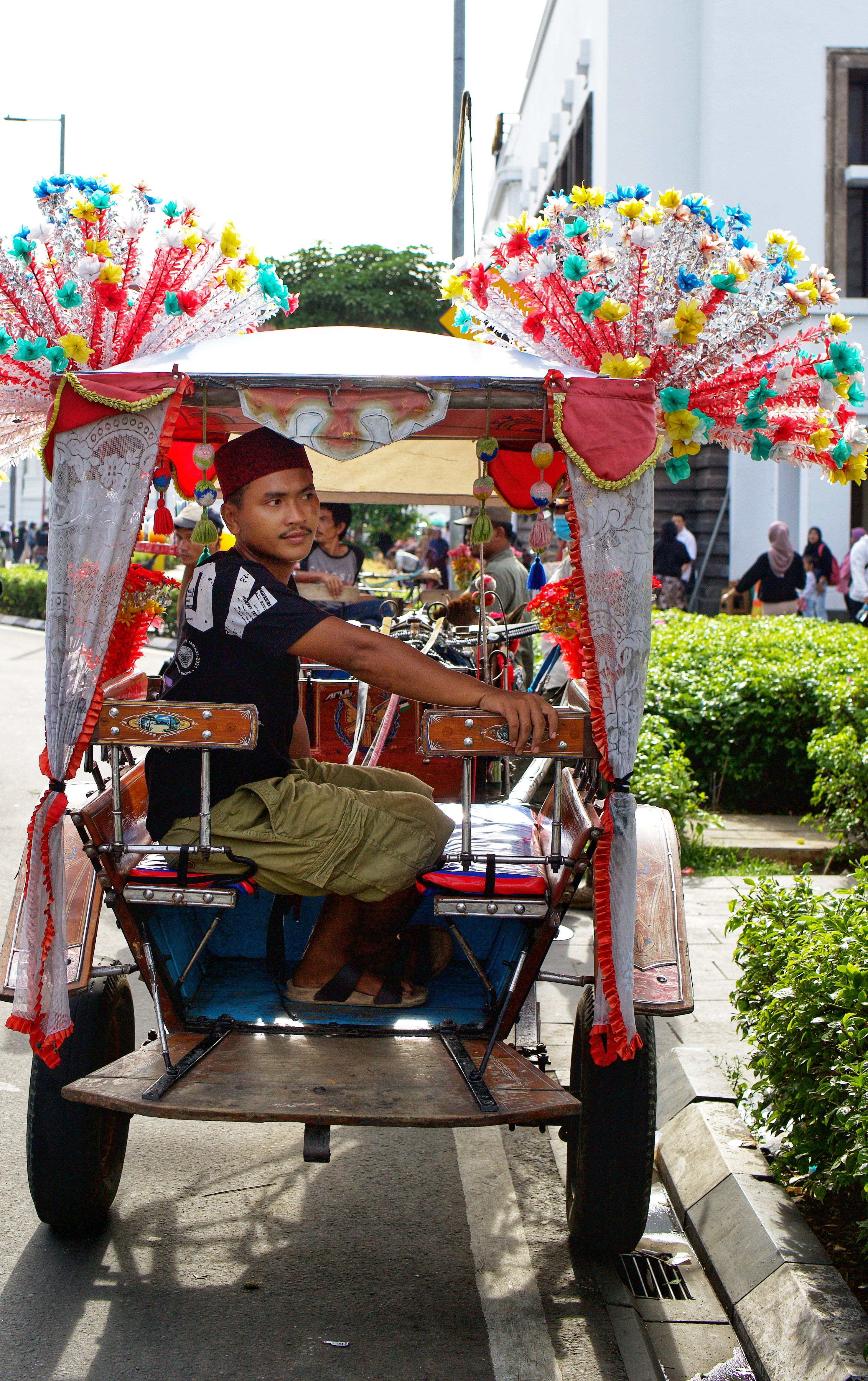 Man Riding in a Rickshaw on a Street during a Parade · Free Stock Photo