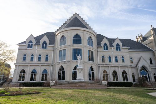 Free Stunning Gothic Revival building with statue in Washington D.C. under a bright sky. Stock Photo
