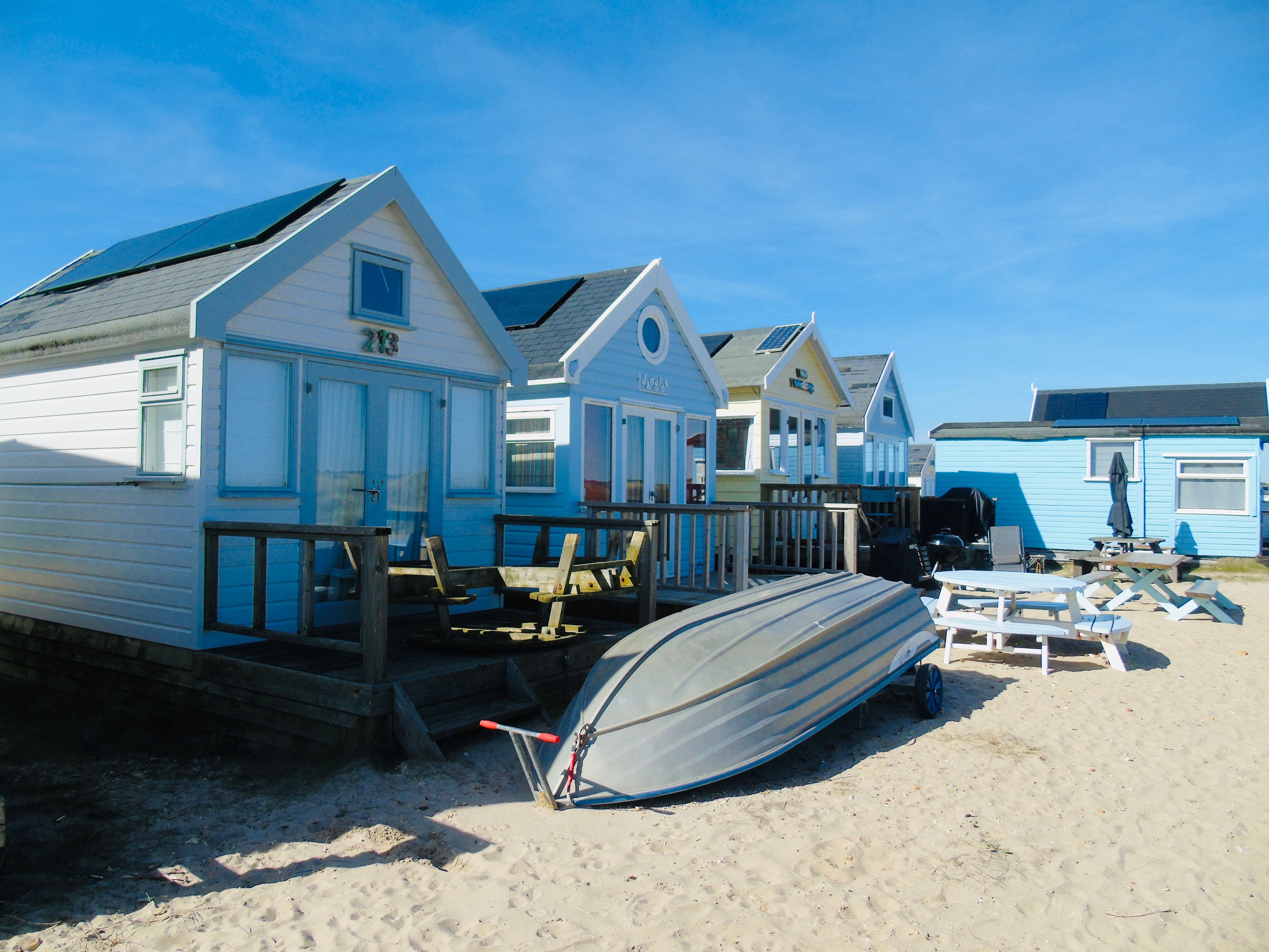 Colorful Beach Huts by the Sea on a Sunny Day · Free Stock Photo
