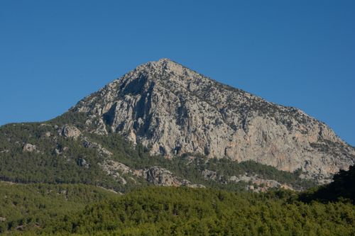 Free Stunning mountain peak under clear blue sky in Antalya, showcasing natural beauty and lush greenery. Stock Photo