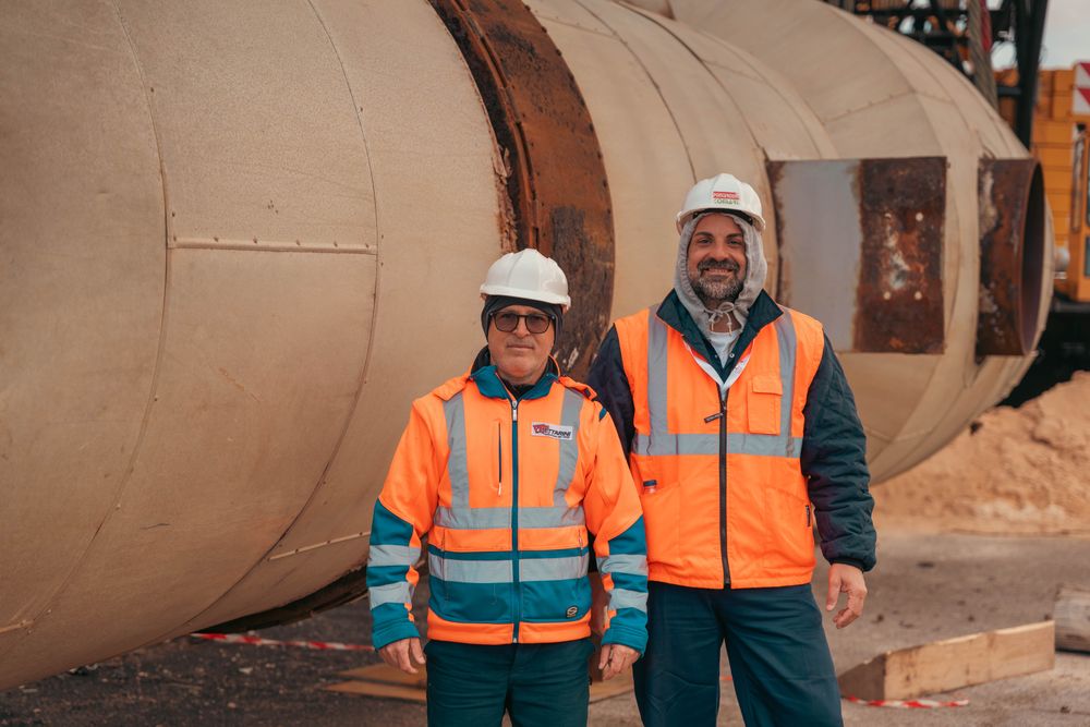 CFO and operations manager walking through a manufacturing facility discussing operating expenses