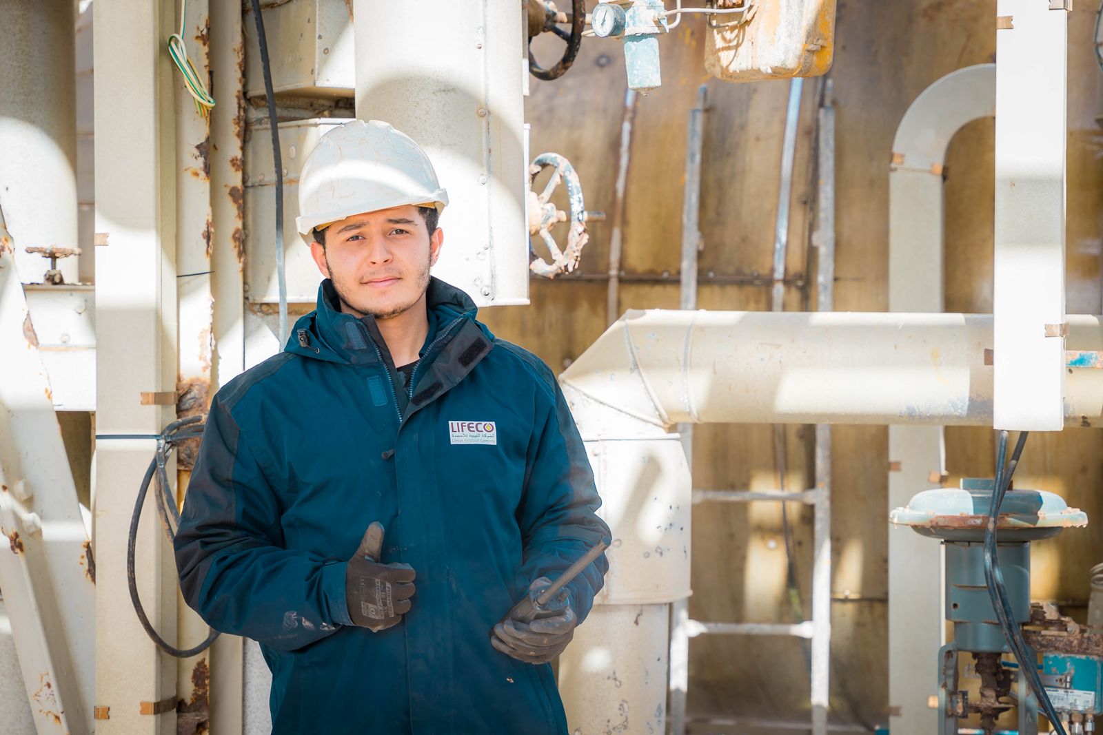 Engineer in safety gear at an industrial facility