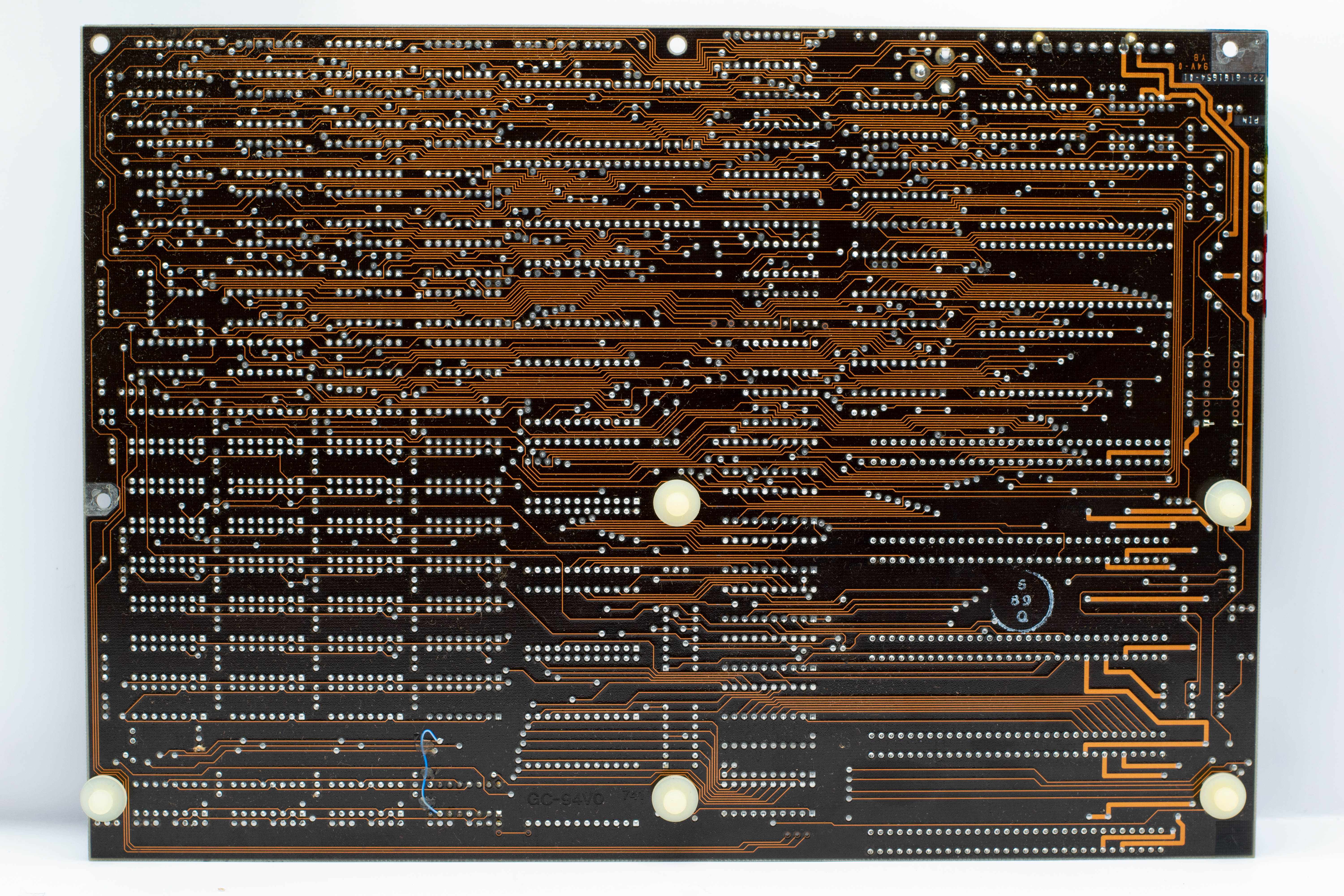 Close-up of a retro circuit board showcasing intricate copper traces and electronic components.