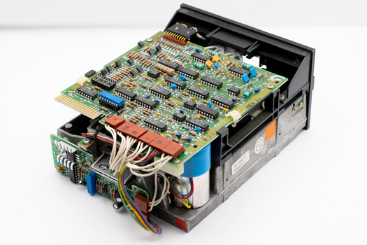 Close-up of a vintage circuit board showcasing electronic components and wires.