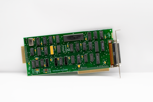 Explore a detailed vintage computer circuit board showcasing retro electronic components and chips.