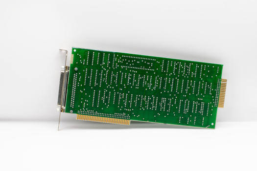 A vintage green circuit board showcasing electronic components, isolated on a white background.