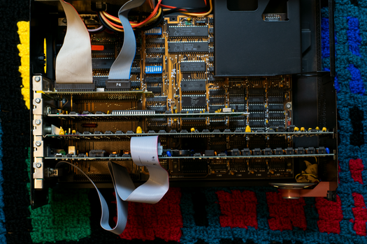 A vintage circuit board showcasing intricate electronic components and ribbon cables.