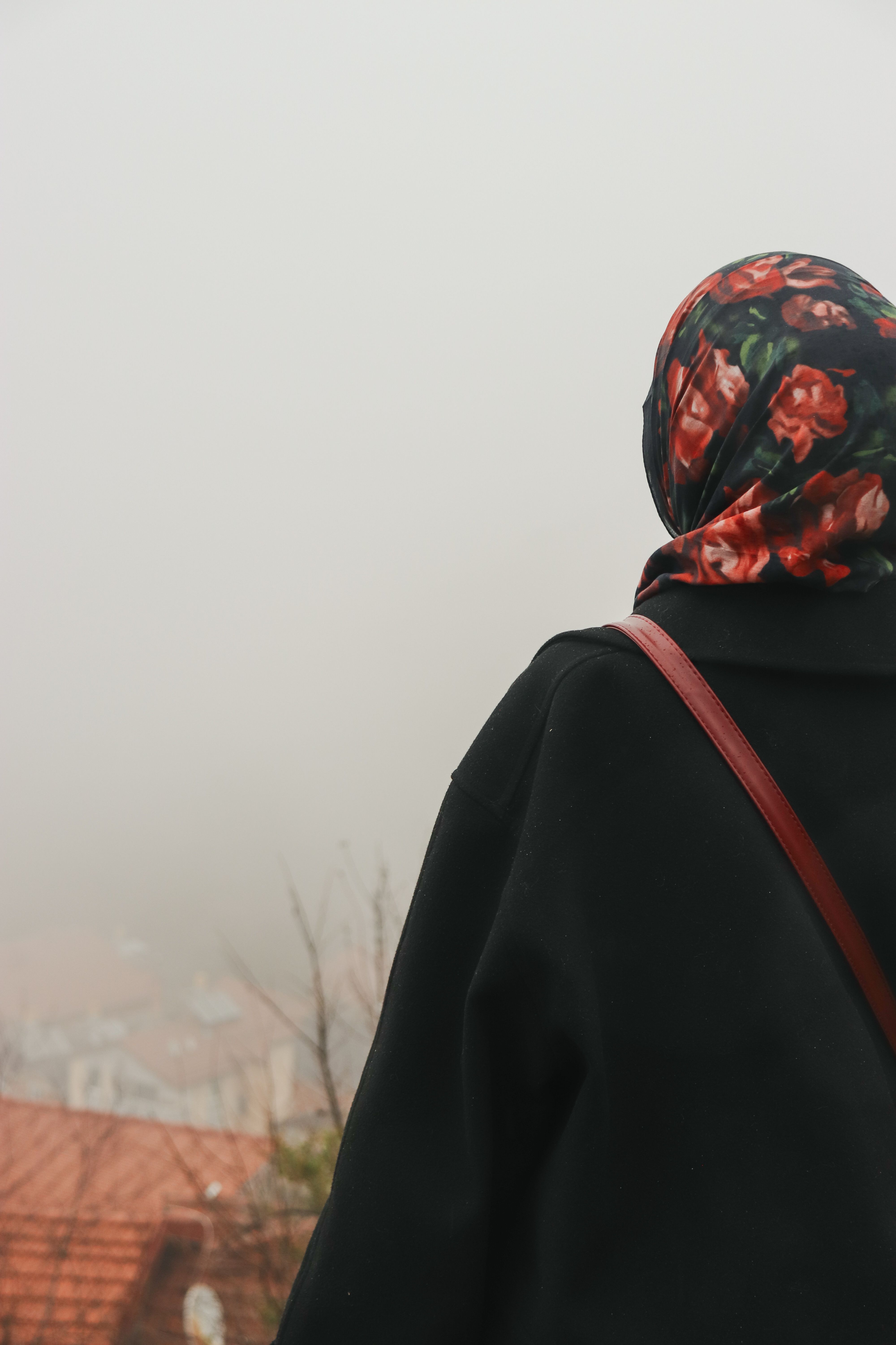 Woman in Hijab Gazing at Sunset in Rural Setting · Free Stock Photo