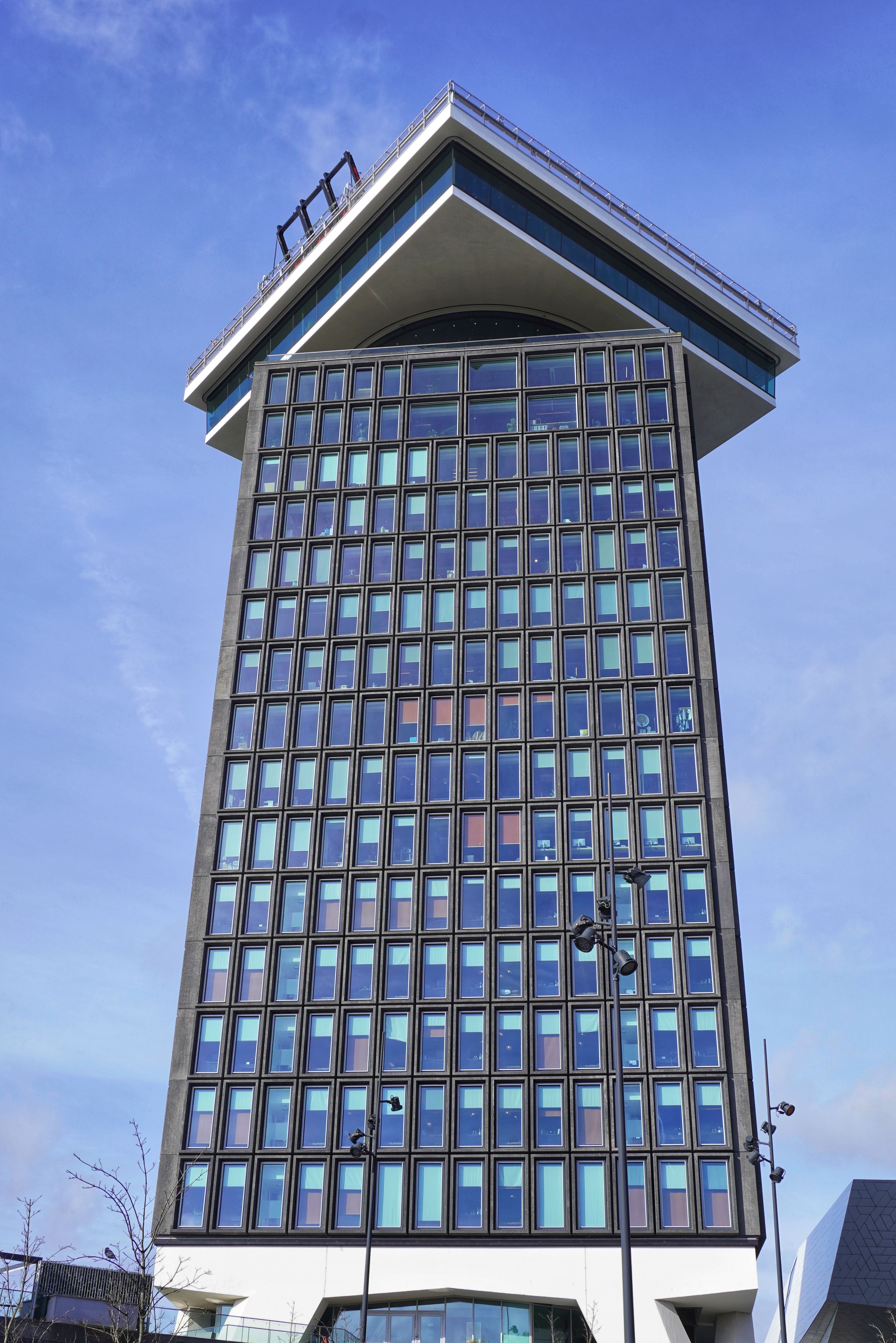 Futuristic High-Rise Building in Urban Setting · Free Stock Photo