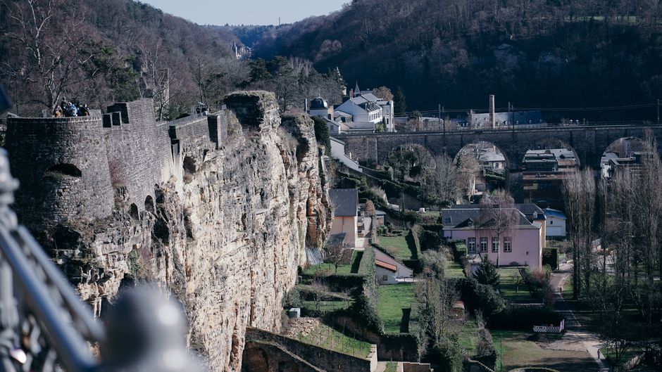 A scenic view of Luxembourg's historic cliffs and fortifications overlooking the city.