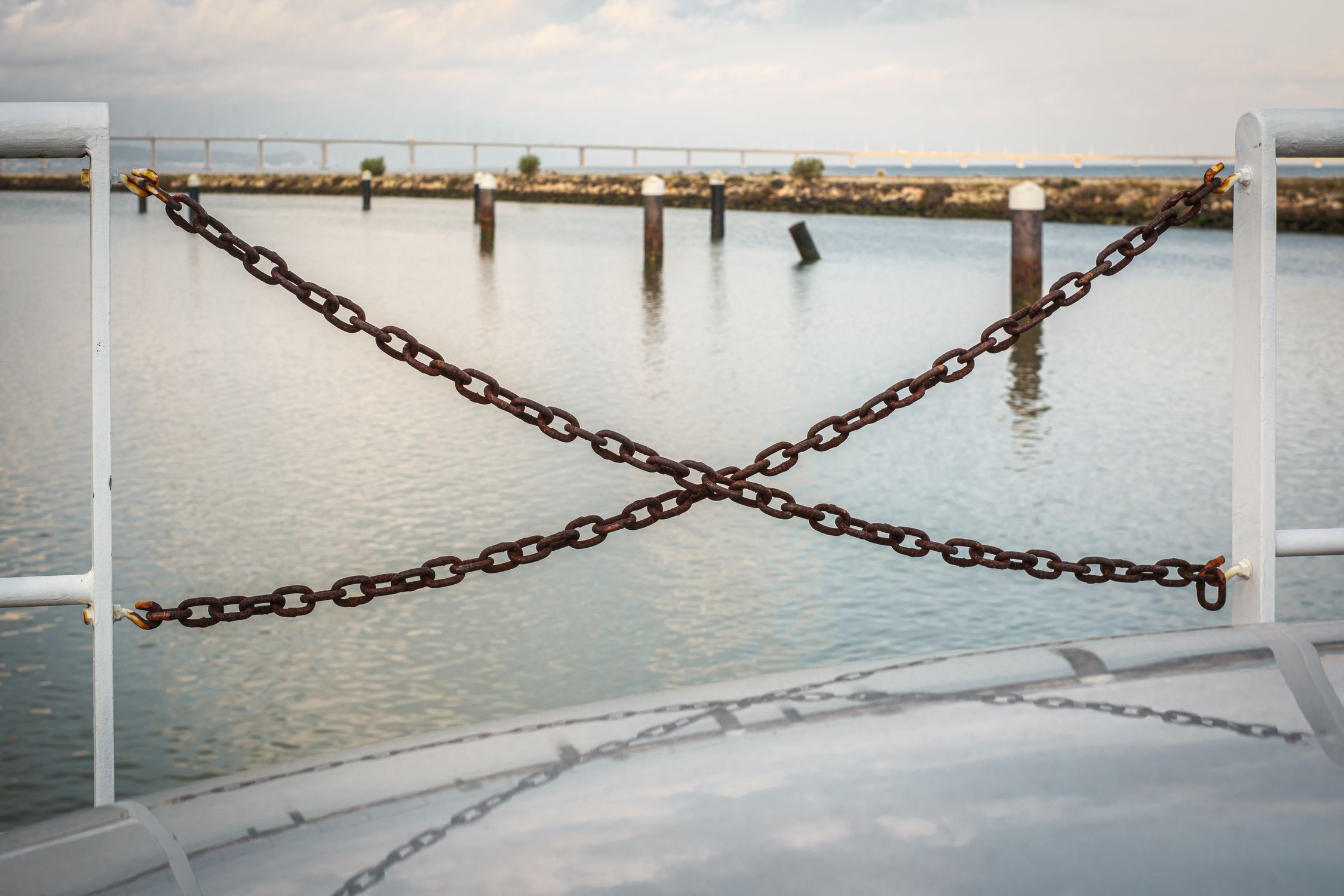 Chain View Serene Waterfront View with Rusted Chains · Free Stock Photo