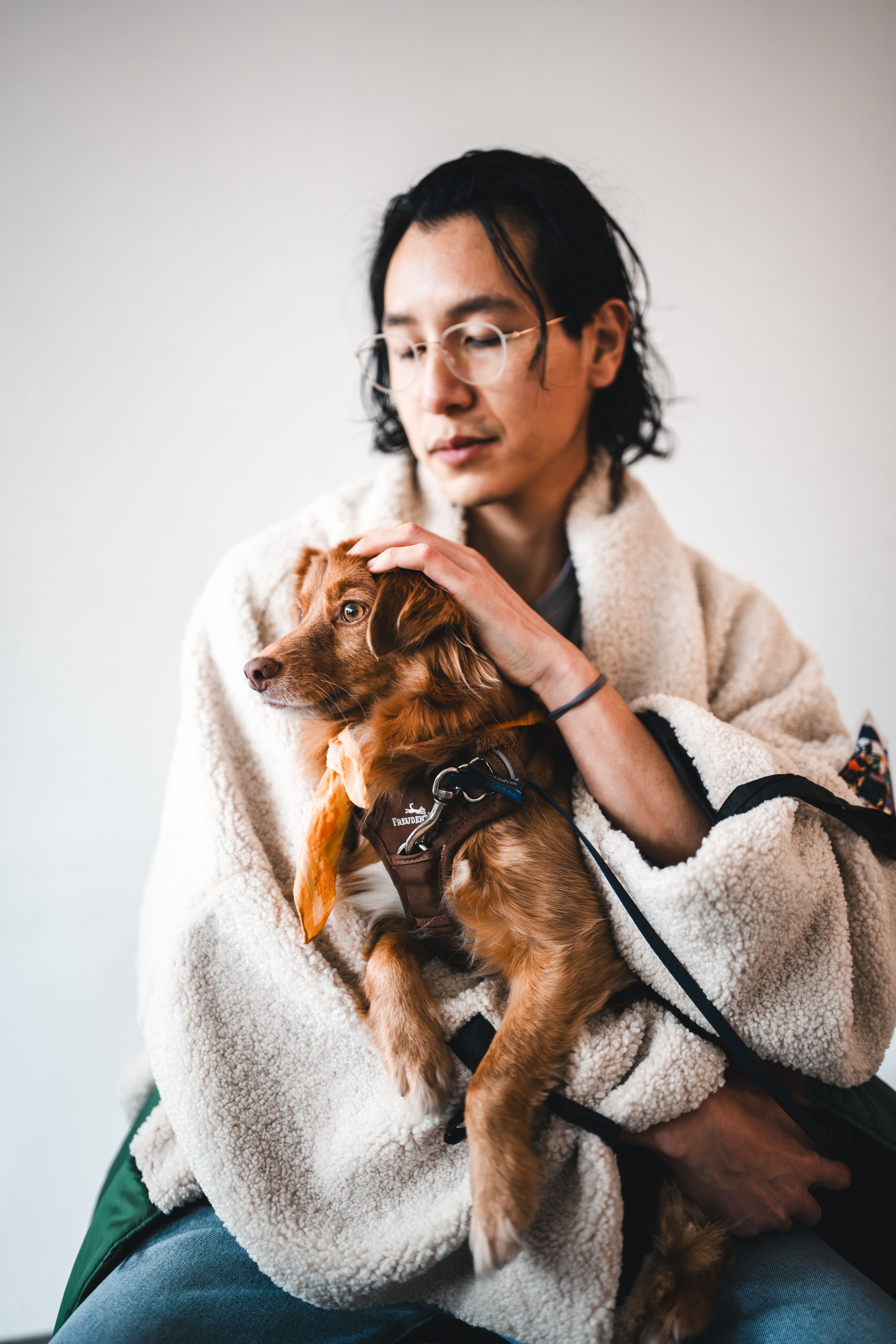 Young man holding a small dog