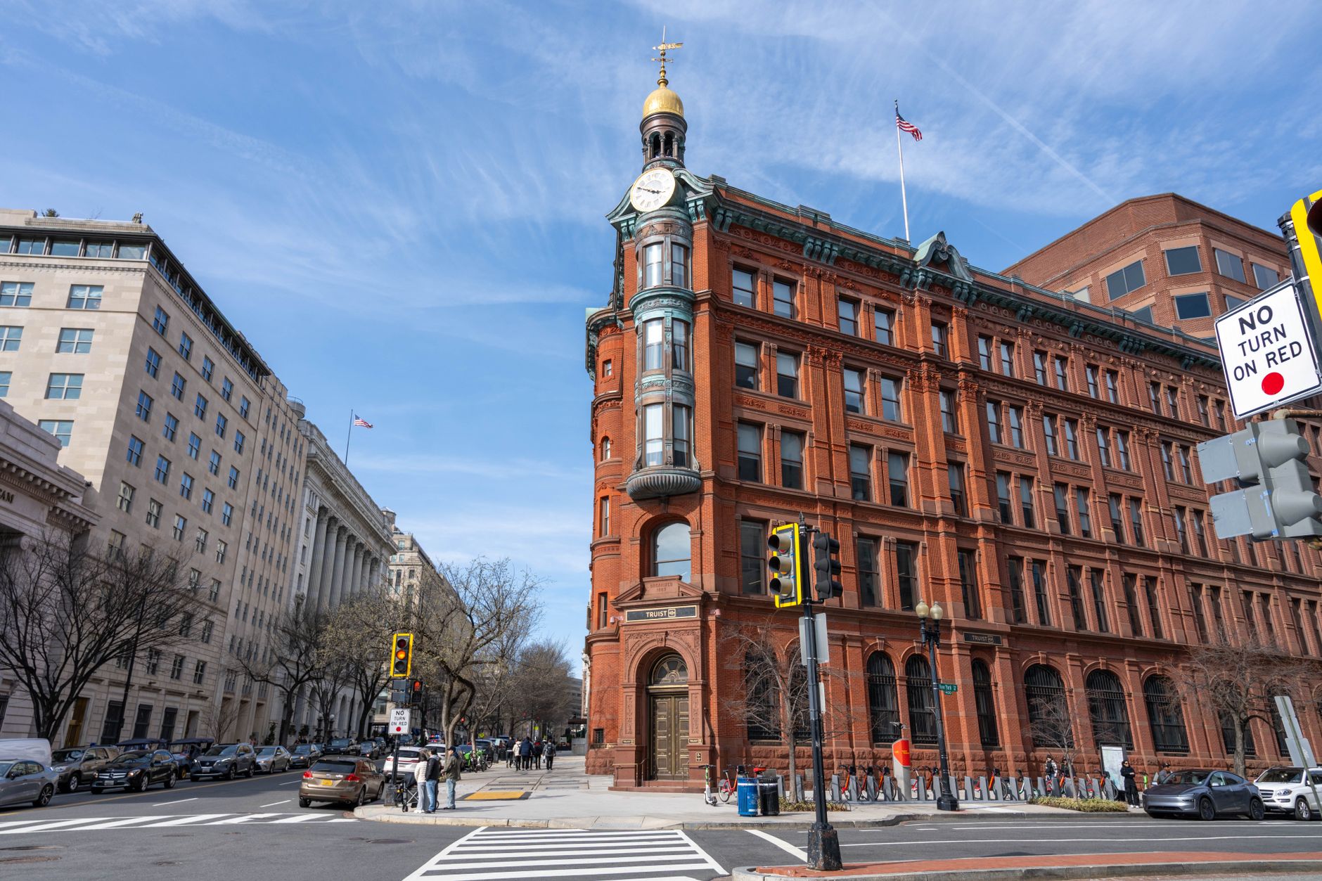 A vibrant daytime view of iconic architecture in Washington, DC, with clear blue skies.