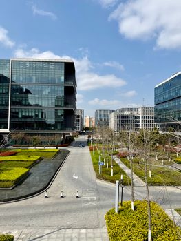 Urban business district with modern glass buildings under a clear blue sky.