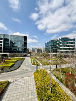 Modern architectural office buildings with open landscaping in Shanghai, China on a sunny day.