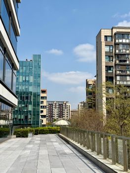 Contemporary buildings under a clear blue sky in Shanghai, showcasing urban architecture.