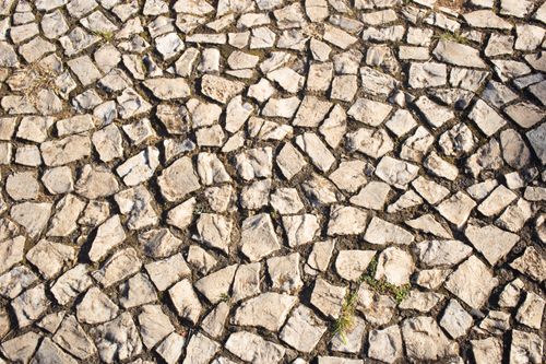 Free Close-up view of a stone mosaic pathway with a natural texture and unique pattern. Stock Photo