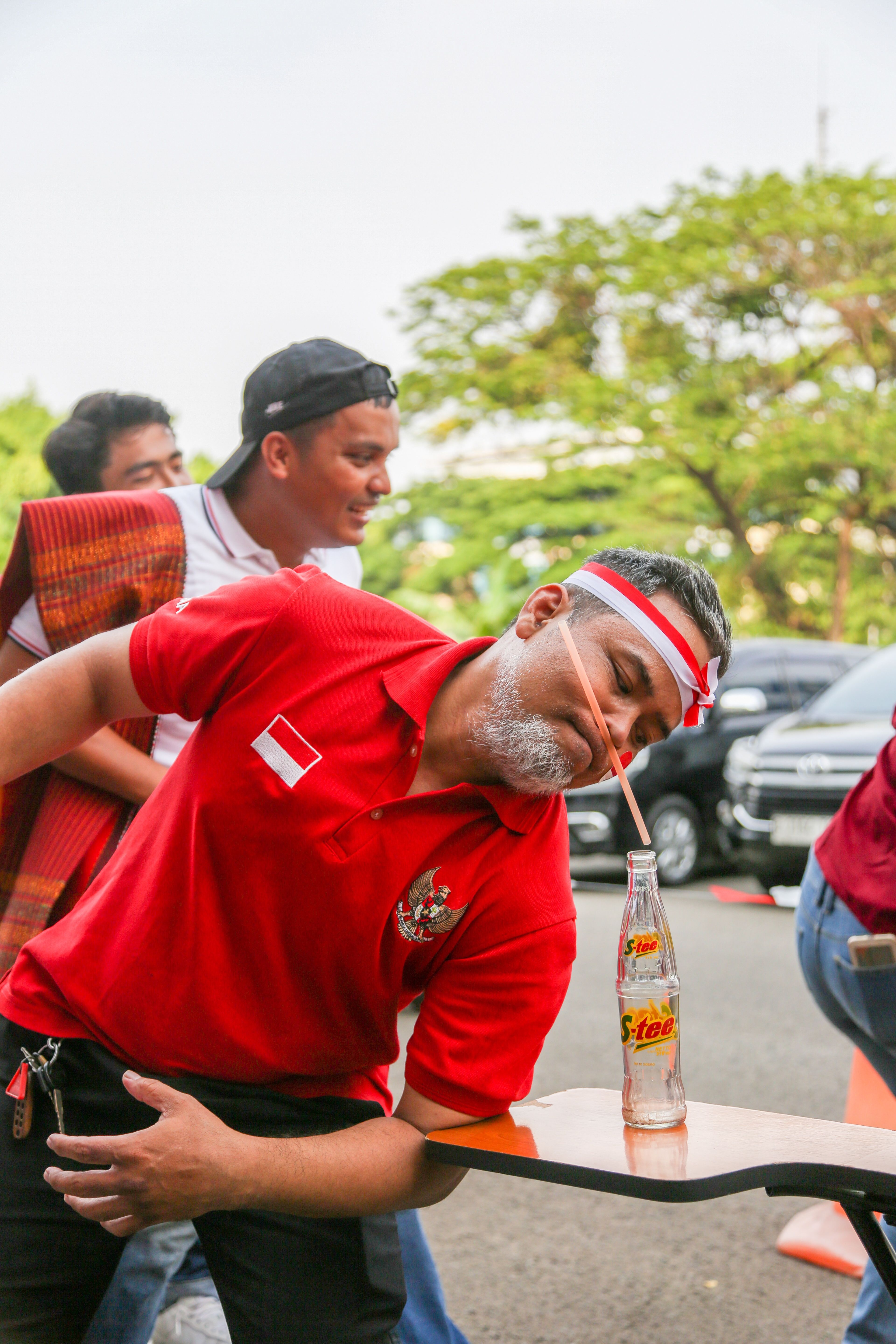 Man Competing in Outdoor Soda Drinking Game