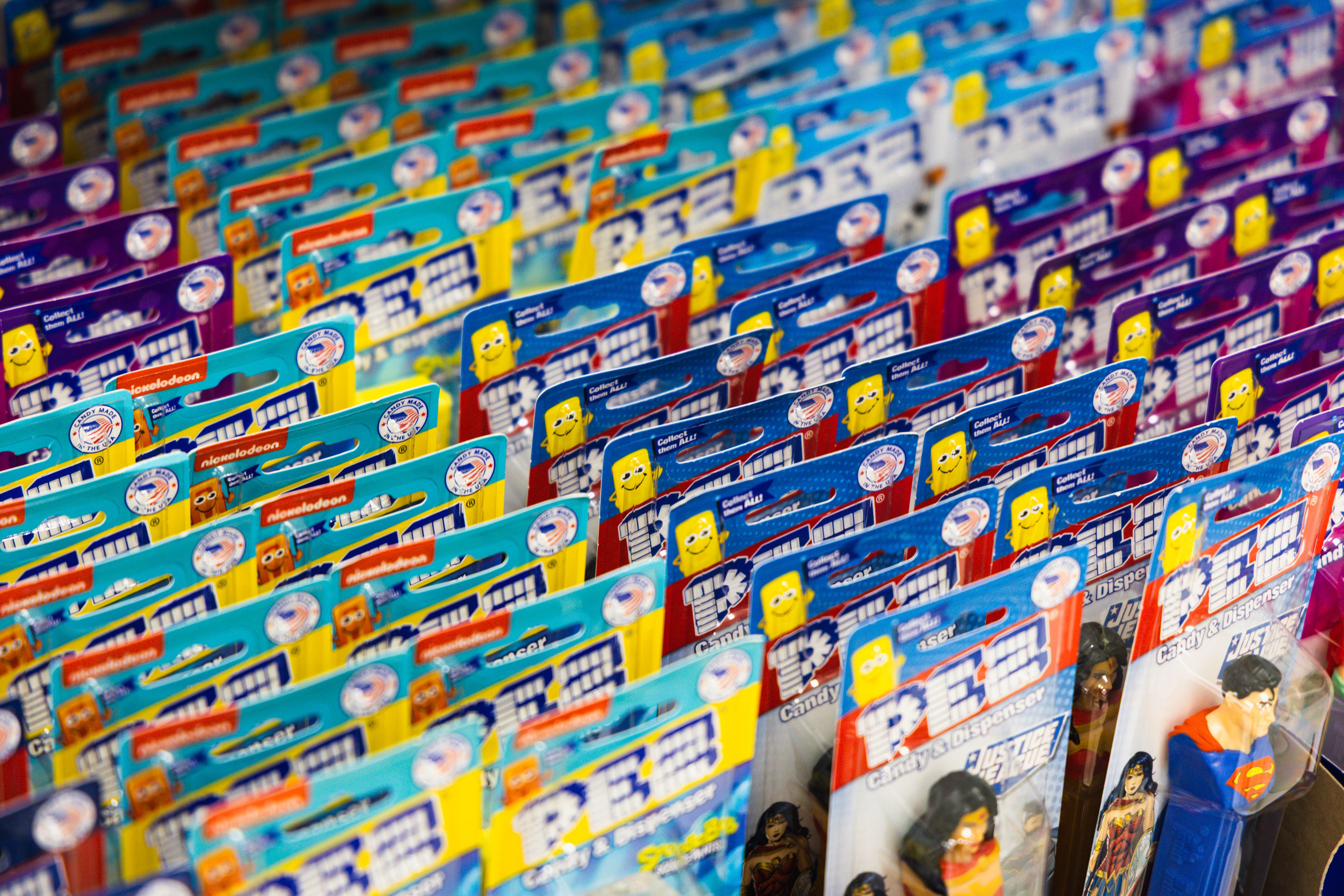 Rows of vibrant PEZ candy dispensers featuring popular characters in playful packaging.