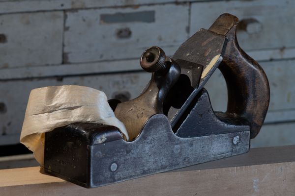 A wooden hand plane on a workshop bench