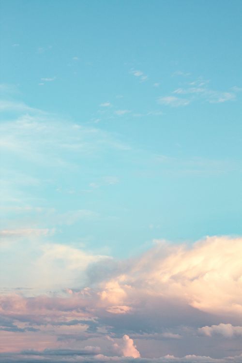 Free Gentle pastel clouds against a bright blue sky, captured over Breves, Brazil. Tranquil and peaceful atmosphere. Stock Photo