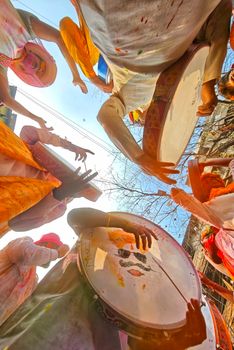 Colorful Holi festival celebration in Kolkata with drummers and participants enjoying the cultural tradition.