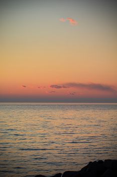 Peaceful sunset view over the calm sea at Grado, Italy, showcasing a warm and vibrant sky reflection.