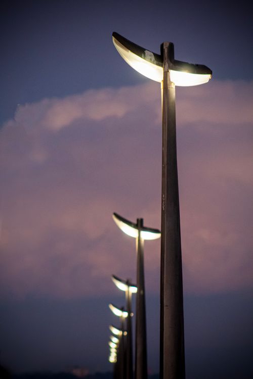 Free Scenic street lights along Grado beach captured at sunset, creating a serene ambiance. Stock Photo