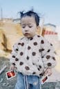 Cute Child in Polka Dot Jacket Holding Cards